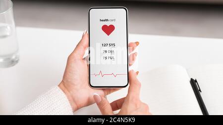 Female hands holding mobile phone with health application showing vital body functions, collage Stock Photo