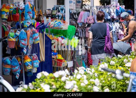 Zingst, Germany. 24th June, 2020. Sales stands with children's toys for the beach and souvenirs are located in front of a shop on the beach promenade. Credit: Jens Büttner/dpa-Zentralbild/dpa/Alamy Live News Stock Photo