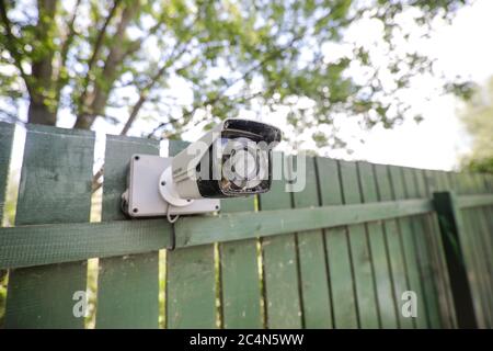 Shallow depth of field (selective focus) image with an unused and cover in spider webs cctv camera. Stock Photo