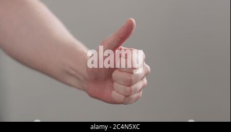 man hand show thumb up over neutral background Stock Photo