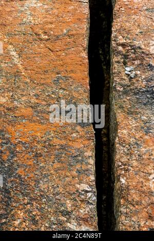 One deep , sharp crack on bedrock surface , Finland Stock Photo