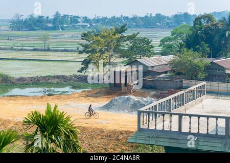 Landscape of Indian village in Assam with white minarets of mosque and ...