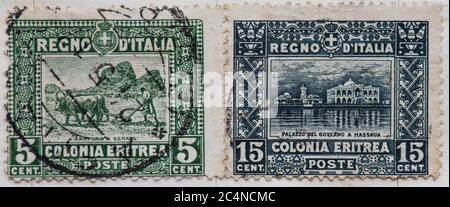 Italian Colonies postage stamp - Eritrea - issued 1910 - 1929, showing ploughing and the Governors Palace Massaua Stock Photo