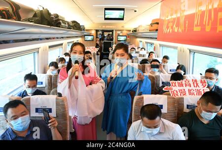 Hefei. 28th June, 2020. Railway staff members stage a performance aboard train No. G9394 travelling from Hefei to Hangzhou on the Shangqiu-Hefei-Hangzhou high-speed railway, June 28, 2020. A new high-speed railway route connecting east and central China started operation on Sunday. With a designed speed of 350 kph, the route connects the city of Shangqiu in central China's Henan Province, and Hefei and Hangzhou, the capital cities of east China's Anhui and Zhejiang provinces. Credit: Liu Junxi/Xinhua/Alamy Live News Stock Photo