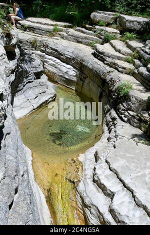 Papingo, Greece - June 07, 2019: Unidentified tourist and natural pools, small waterfalls and rock formations named The Ovires in Vikos-Aoos national Stock Photo