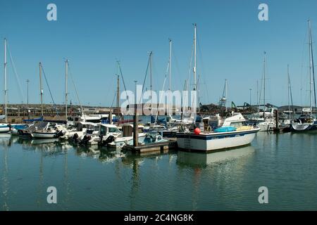 View of Newhaven Marina view of boats and yachts at moorings on a warm and sunny summers day on the the South Coast of England. Stock Photo