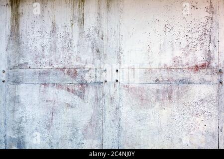 Old whitewashed weathered distressed cracked cement stone wall texture background Stock Photo