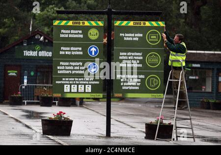 Gary Gilmour installs information signs at the entrance to Blair Drummond Safari Park near Stirling where staff are preparing to open the attraction on June 29 as part of Scotland's phased release of the coronavirus pandemic lockdown. Stock Photo