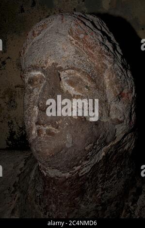 Face of Etruscan man interred more than 2,000 years ago.  Stone sculpture on Etruscan sarcophagus in archaeological museum at Tarquinia, Lazio, Italy. Stock Photo