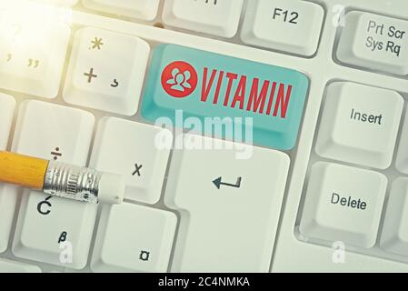 Handwriting text writing Vitamin. Conceptual photo organic molecule that is essential micronutrient that organism needs White pc keyboard with empty n Stock Photo