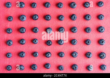Colorful fruit pattern of blueberries on pink background. Top view. Flat lay Stock Photo