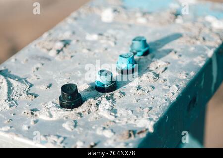 Black aerosol caps, spray cans stand on an old iron chtol smeared with paint Stock Photo