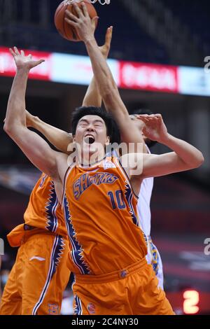 Qingdao, China's Shandong Province. 28th June, 2020. Dong Hanlin (Front) of Shanghai Sharks vies for the ball during a match between Beijing Ducks and Shanghai Sharks at the newly resumed 2019-2020 Chinese Basketball Association (CBA) league in Qingdao, east China's Shandong Province, June 28, 2020. Credit: Li Ziheng/Xinhua/Alamy Live News Stock Photo