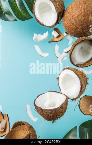 Halves of coconut, open cut in half isolated on blue background. Coconut pulp is very healthy wholesome food. Top view, copy space, place for text.Coc Stock Photo