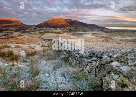 Old Stone Wall In British Countryside At Sunrise On A Cold Frosty Morning. Lake District, UK. Stock Photo