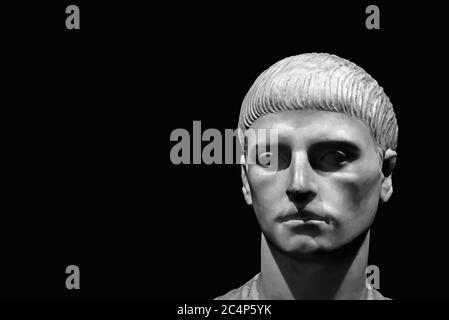 Black and white photo in close-up of head of ancient roman marble sculpture of a young man with short hair Stock Photo