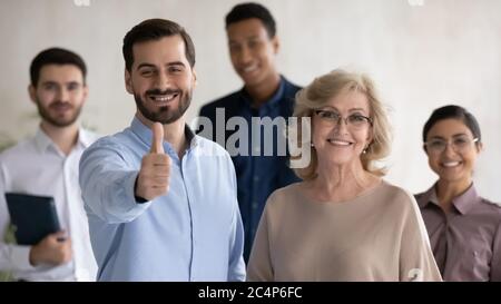 Head shot portrait two team leaders with diverse employees team Stock Photo