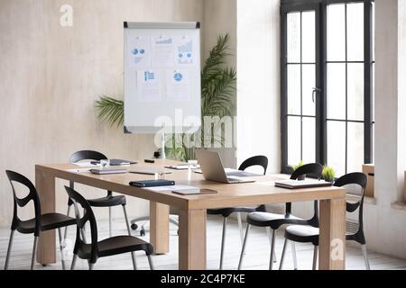 Modern office boardroom with flip chart and conference table Stock Photo