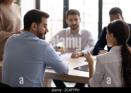 Rear view businesswoman speaking, discussing project at corporate meeting Stock Photo