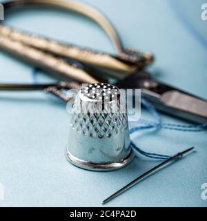 vintage silver thimble on blue Stock Photo