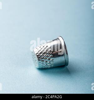 vintage silver thimble on blue Stock Photo
