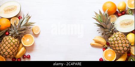 Tropical fruit on white wooden background Stock Photo