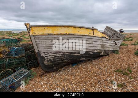 The wreck of an old wooden fishing boat on the shingle beach at Dungeness, Kent, England, UK Stock Photo