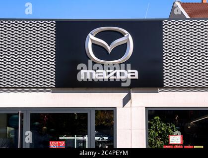 Nuremberg, GERMANY: Mazda dealership sign against blue sky. Mazda is a Japanese automaker and produces over 1 million vehicles per year. Stock Photo