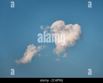 Heart shaped cloud in blue sky