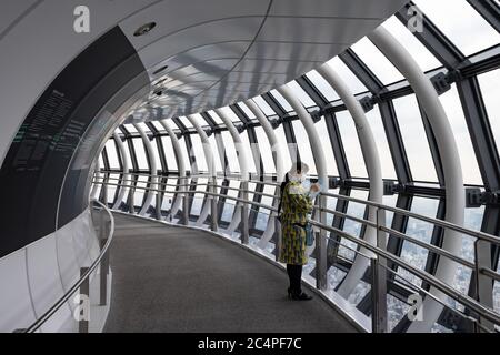 Employee in colorful uniform at Tokyo Skytree Tower Observation Deck - also known as 'Tembo Gallery' starting at the 445th floor. Stock Photo