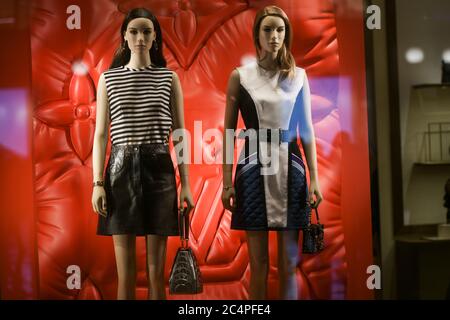 Milan, Italy - January 13, 2020: Louis Vuitton silver summer outfits in a red showcase Stock Photo