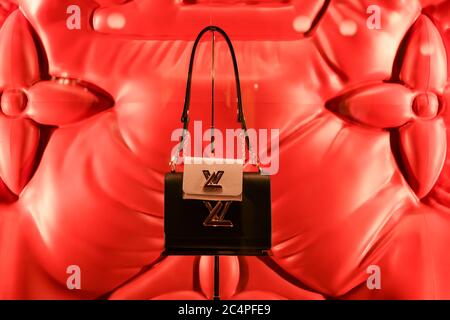 Milan, Italy - January 11, 2020: Louis Vuitton black purse with a mini pink purse attached display Stock Photo