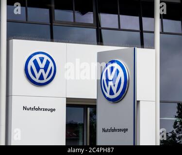 Schwabach, Bayern : the VW logo of the brand 'Volkswagen' at a car dealer building. Volkswagen AG is a German automotive manufacturing company. Stock Photo