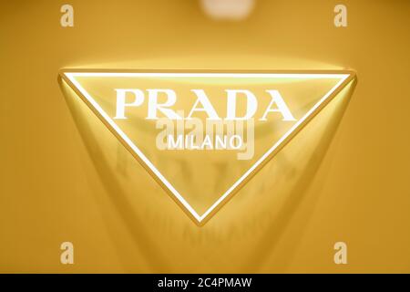 Milan, Italy - January 11, 2020: Lighted yellow Prada store logo Stock Photo