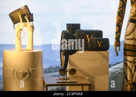 Milan, Italy - January 11, 2020: Versace black leather bumbag and sunglasses display Stock Photo