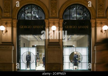 Milan, Italy - January 13, 2020: Giorgio Armani lighted showcases at night Stock Photo