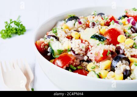 Healthy vegan quinoa fresh salad on white table. Close up. Stock Photo