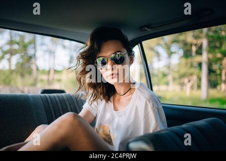 Portrait of a girl in the back seat of a car. Stock Photo