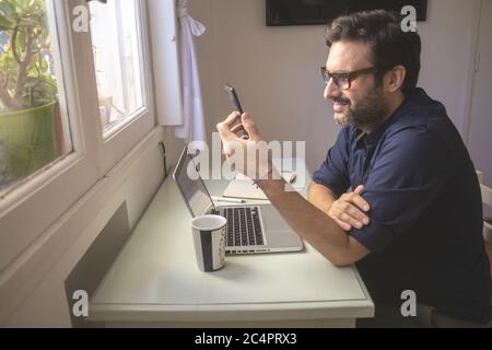 Man working from home in quarantine time for Covid-19 Stock Photo