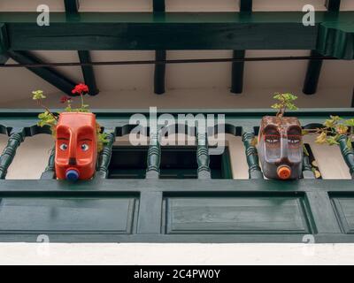 Decorative plastic pots made from plastic bottles in a colonial balcony of a house at the colonial Town of Villa de Leyva, in the Andean mountains of Stock Photo