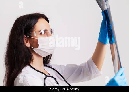 Female doctor examines an MRI image of a patient Stock Photo