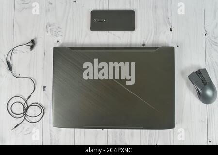 Notebook with cellphone headphones mouse on table Stock Photo