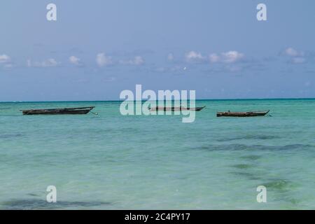 Wooden dhows in the ocean, off the coast of Jambiani in Zanzibar, Tanzania Stock Photo