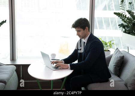 Business man using laptop computer, young businessman busy typing Stock Photo