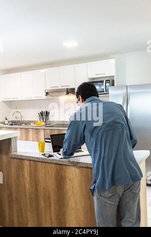 Man working at home on his laptop Stock Photo