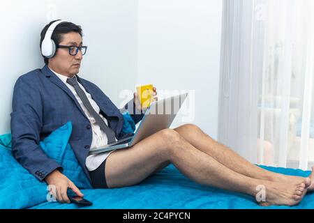 Man with headphones on a video conference works at home Stock Photo