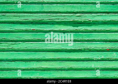 green painted old peeling and cracked weathered wooden slats on a vintage background showing texture Stock Photo