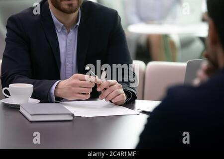 Close up of business advisor making notes while meeting client Stock Photo
