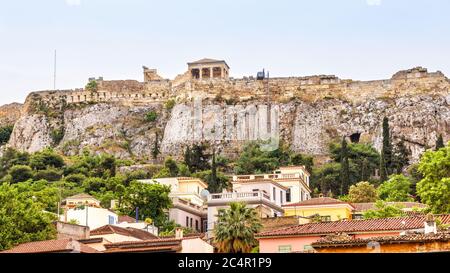 Acropolis of Athens behind Plaka district, Greece. It is a top landmark of old Athens. Panorama of the Acropolis hill with Ancient Greek ruins in the Stock Photo