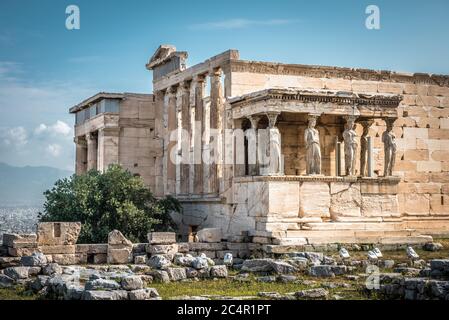 Erechtheion temple with Caryatid Porch on the old Acropolis, Athens, Greece. It is a famous landmark of Athens. Scenic view of Ancient Greek ruins. Be Stock Photo